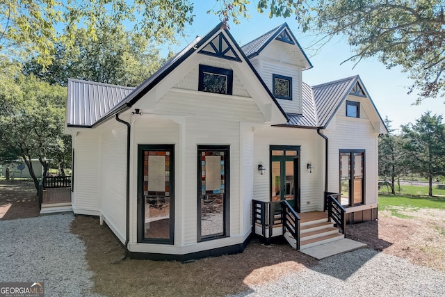 view of front of house featuring french doors, metal roof, and a standing seam roof