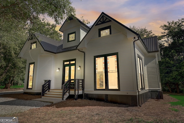 modern farmhouse style home with metal roof and french doors