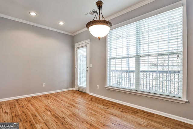 spare room featuring ornamental molding, recessed lighting, light wood-style flooring, and baseboards