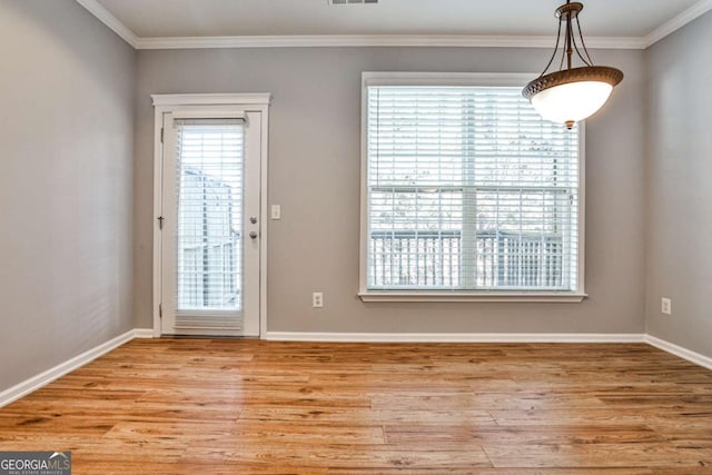 unfurnished dining area featuring light wood finished floors, baseboards, and ornamental molding