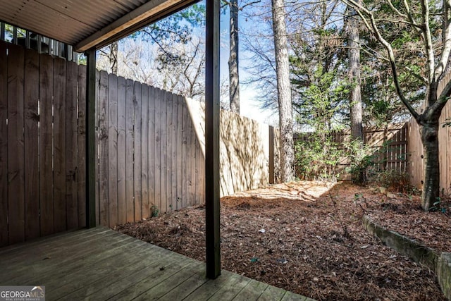 view of yard with a fenced backyard and a wooden deck