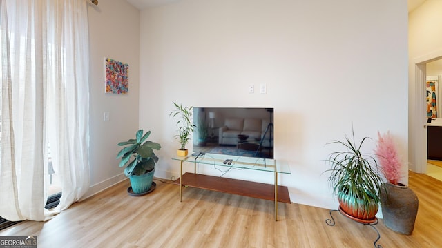 112 Rogers St Unit 409, Atlanta, GA 30317 - sitting room with baseboards and wood finished floors