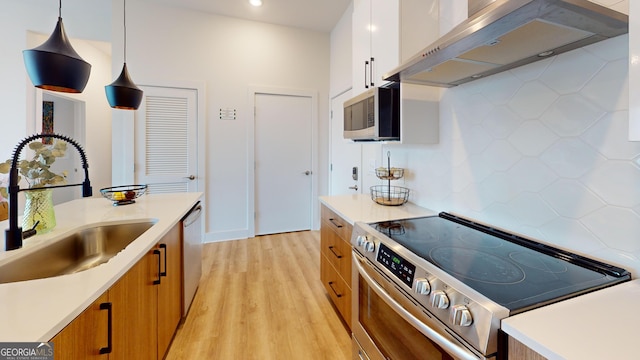 112 Rogers St Unit 409, Atlanta, GA 30317 - kitchen featuring stainless steel appliances, light countertops, brown cabinetry, a sink, and extractor fan