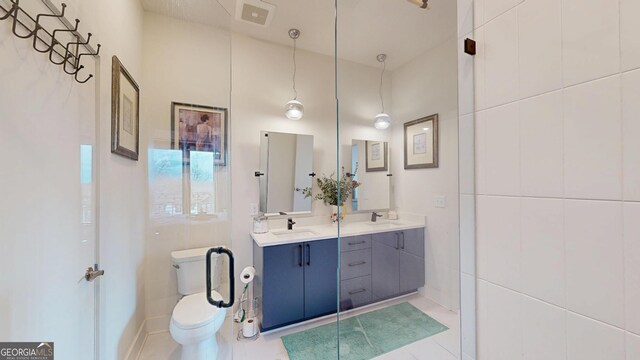 112 Rogers St Unit 409, Atlanta, GA 30317 - bathroom featuring toilet, double vanity, visible vents, and a sink