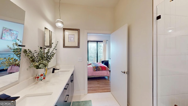 112 Rogers St Unit 409, Atlanta, GA 30317 - ensuite bathroom with double vanity, connected bathroom, a sink, baseboards, and tile patterned floors