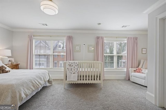 bedroom featuring multiple windows, baseboards, crown molding, and carpet flooring