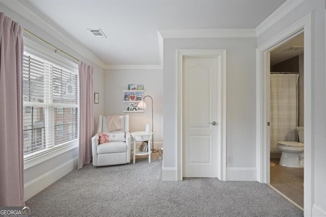 sitting room with baseboards, crown molding, visible vents, and carpet flooring