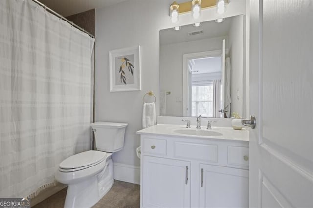 bathroom featuring visible vents, toilet, vanity, tile patterned flooring, and baseboards