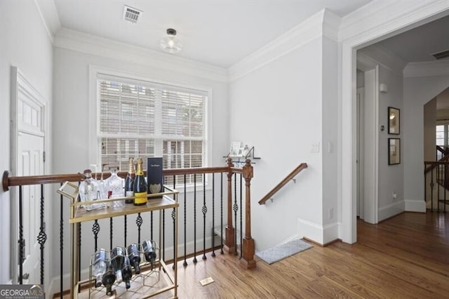 hallway featuring a wealth of natural light, arched walkways, wood finished floors, and an upstairs landing