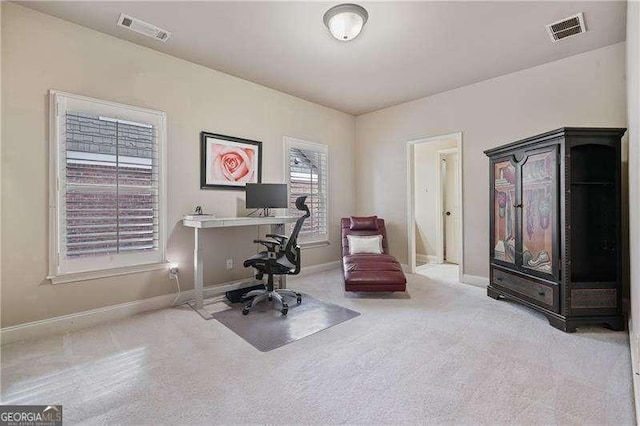 office featuring carpet, visible vents, and baseboards