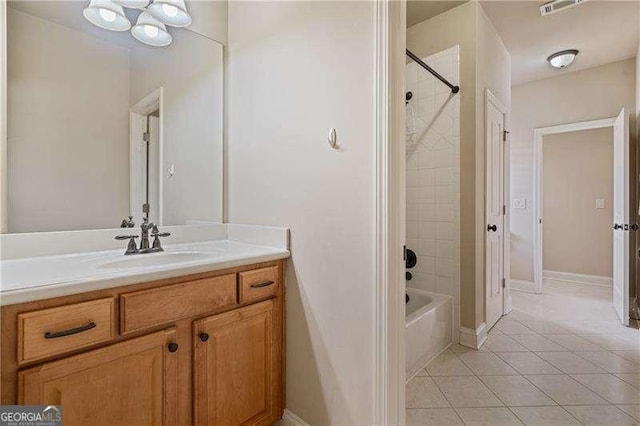 bathroom with bathtub / shower combination, visible vents, vanity, tile patterned flooring, and baseboards