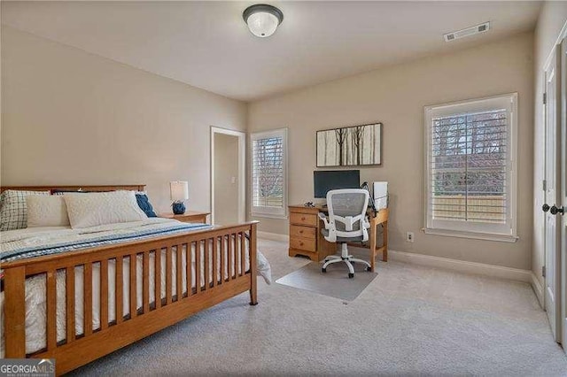 bedroom with light carpet, baseboards, and visible vents