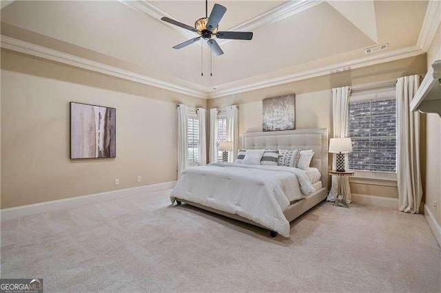 carpeted bedroom with baseboards, a raised ceiling, visible vents, and crown molding