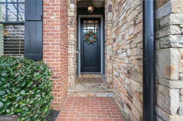 doorway to property with brick siding