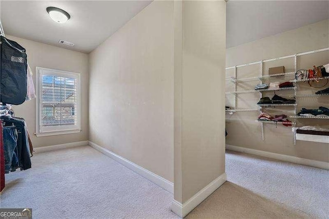 spacious closet with carpet and visible vents