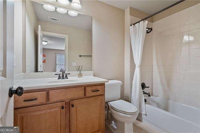 full bathroom featuring toilet, shower / tub combo, vanity, and visible vents