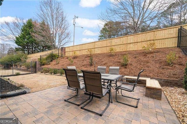 view of patio with outdoor dining space and a fenced backyard