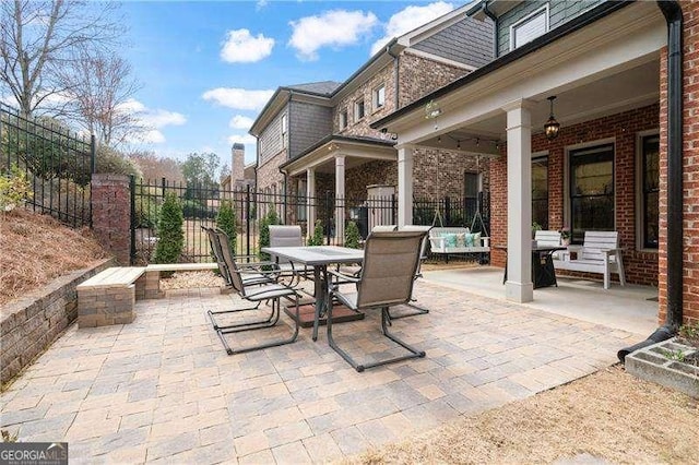 view of patio / terrace with outdoor dining area and fence