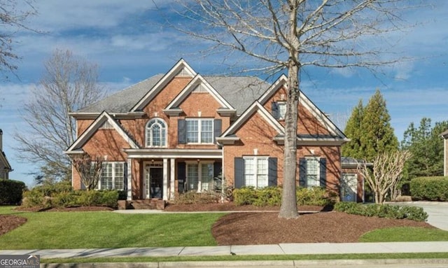 view of front of property with brick siding and a front yard