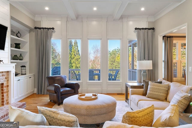 living room with coffered ceiling, a brick fireplace, and light wood-style flooring