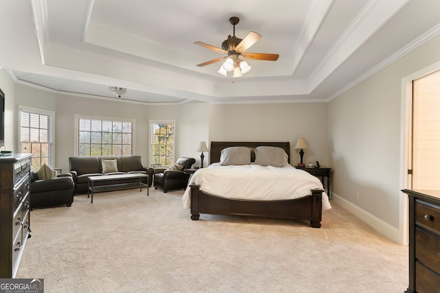 bedroom with a tray ceiling, baseboards, and light colored carpet