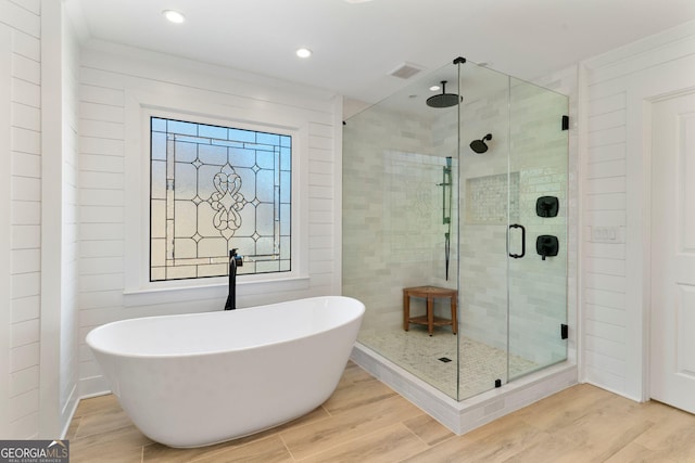 full bathroom featuring visible vents, a shower stall, recessed lighting, wood finished floors, and a soaking tub