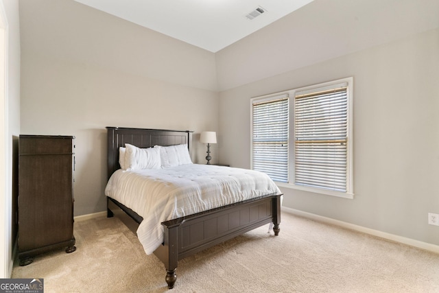 bedroom featuring light carpet, visible vents, and baseboards