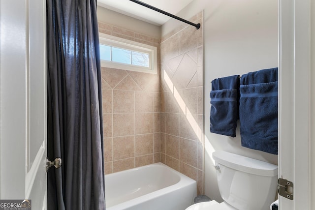 bathroom featuring shower / bath combination with curtain and toilet