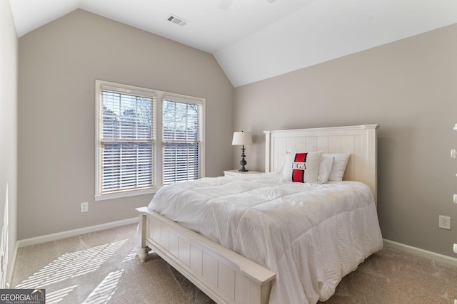 bedroom with visible vents, carpet floors, baseboards, and vaulted ceiling