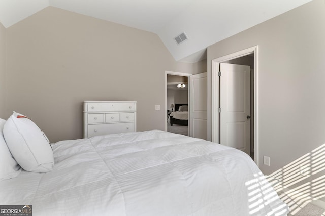 bedroom featuring visible vents and vaulted ceiling