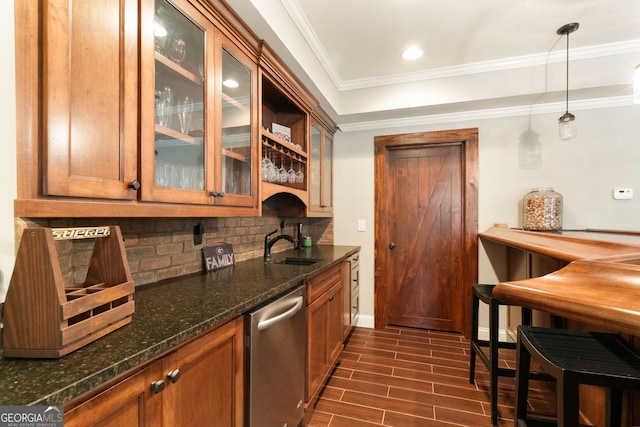 kitchen featuring stainless steel dishwasher, decorative backsplash, brown cabinetry, and wood tiled floor