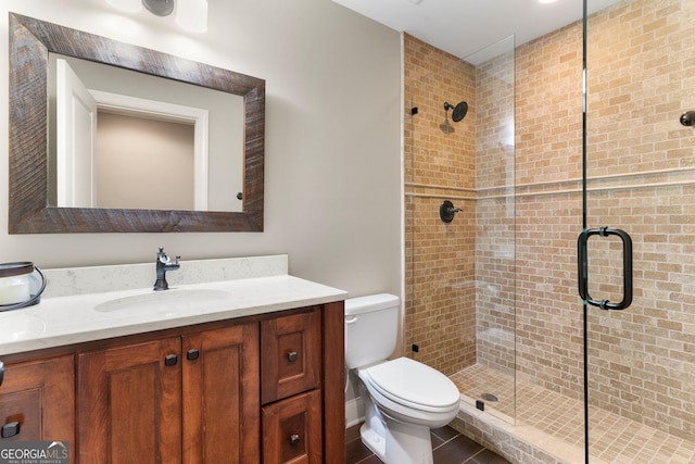 full bathroom featuring a stall shower, toilet, and vanity