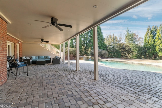 view of patio featuring stairway, an outdoor living space, an outdoor pool, and ceiling fan