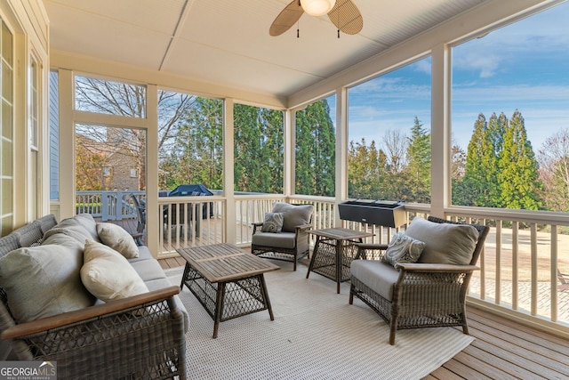 sunroom with a wealth of natural light and ceiling fan