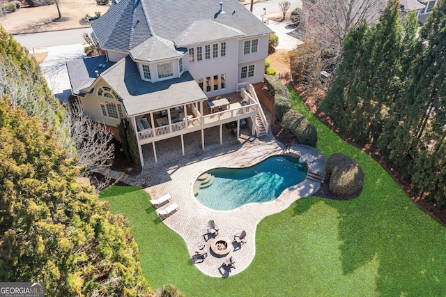 exterior space featuring a yard, a deck, stairs, and a patio