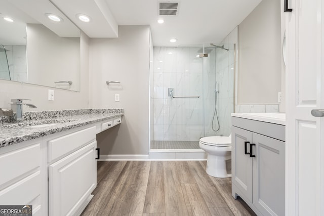 3481 Lakeside Dr NE Unit 2303, Atlanta, GA 30326 - bathroom featuring vanity, a marble finish shower, wood finished floors, and recessed lighting