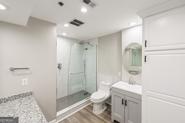 3481 Lakeside Dr NE Unit 2303, Atlanta, GA 30326 - bathroom with a marble finish shower, visible vents, toilet, and wood finished floors