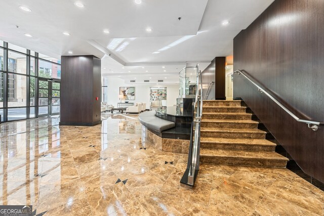 3481 Lakeside Dr NE Unit 2303, Atlanta, GA 30326 - stairs featuring floor to ceiling windows, recessed lighting, marble finish floor, and a raised ceiling
