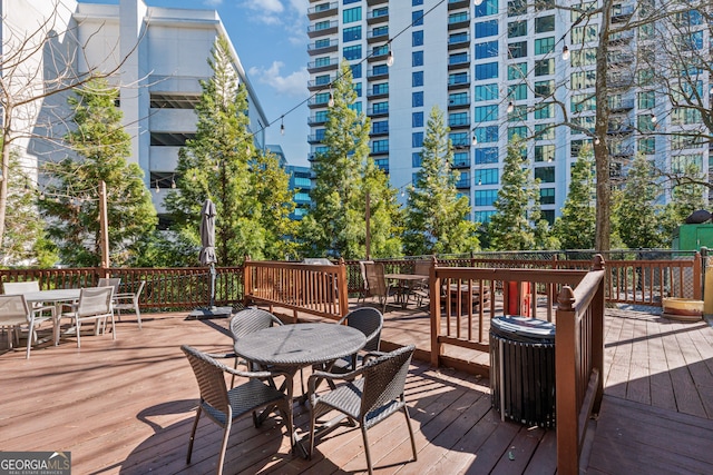 3481 Lakeside Dr NE Unit 2303, Atlanta, GA 30326 - wooden terrace with outdoor dining area