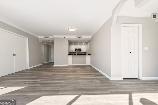 3481 Lakeside Dr NE Unit 2303, Atlanta, GA 30326 - unfurnished living room with visible vents, wood finished floors, baseboards, and ornamental molding