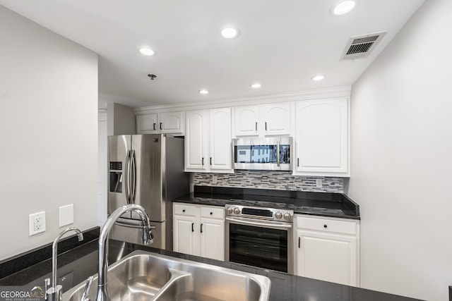 3481 Lakeside Dr NE Unit 2303, Atlanta, GA 30326 - kitchen featuring stainless steel appliances, dark countertops, white cabinetry, and recessed lighting