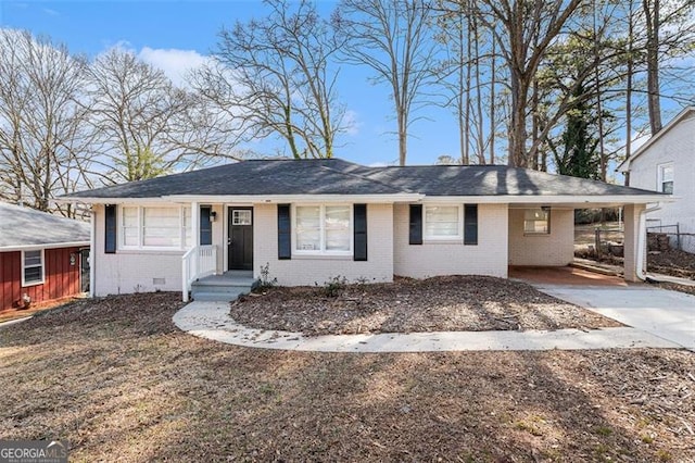 single story home featuring crawl space, brick siding, and driveway