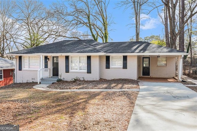 ranch-style house with crawl space, a shingled roof, and brick siding