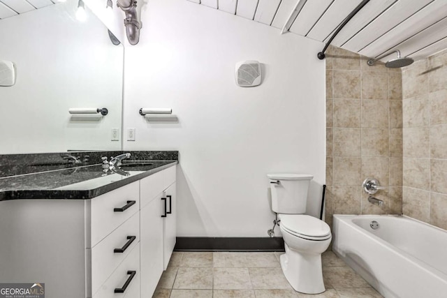 bathroom featuring toilet, tub / shower combination, vanity, baseboards, and tile patterned floors