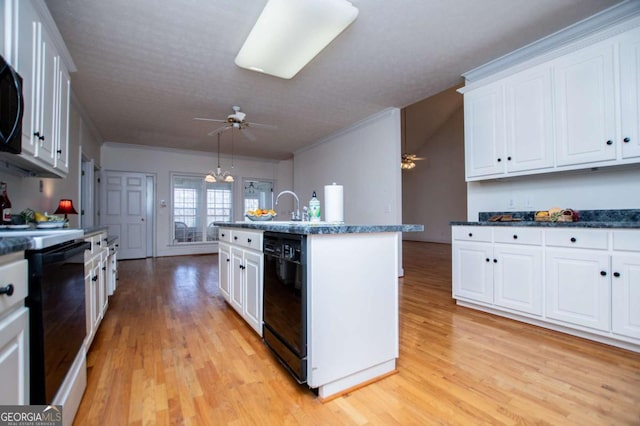 kitchen with white cabinets, light wood-type flooring, black dishwasher, and range