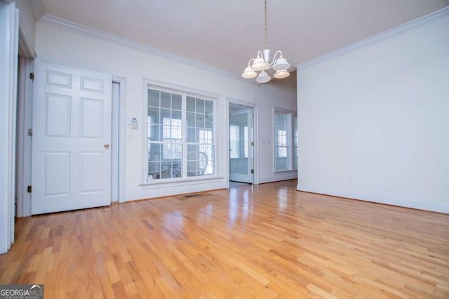 interior space featuring a chandelier, ornamental molding, baseboards, and light wood-style floors