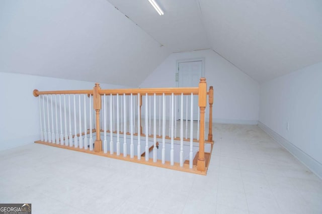 additional living space with lofted ceiling and baseboards