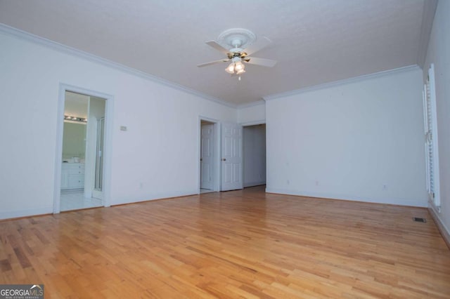 interior space featuring ceiling fan, light wood-type flooring, baseboards, and crown molding