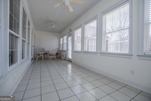 unfurnished sunroom featuring a ceiling fan