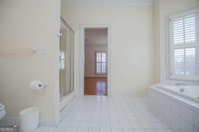 bathroom featuring crown molding, a stall shower, tiled tub, and tile patterned floors